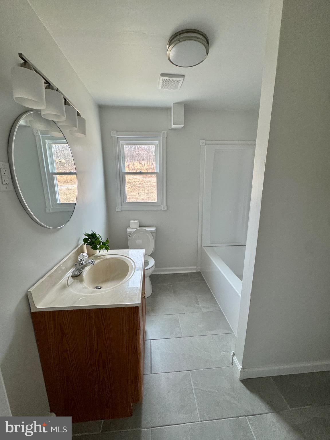 18712 Crossland Road Southwest Rawlings, MD 21557 - Photo 68 of 89 a bathroom with a sink a toilet and a mirror