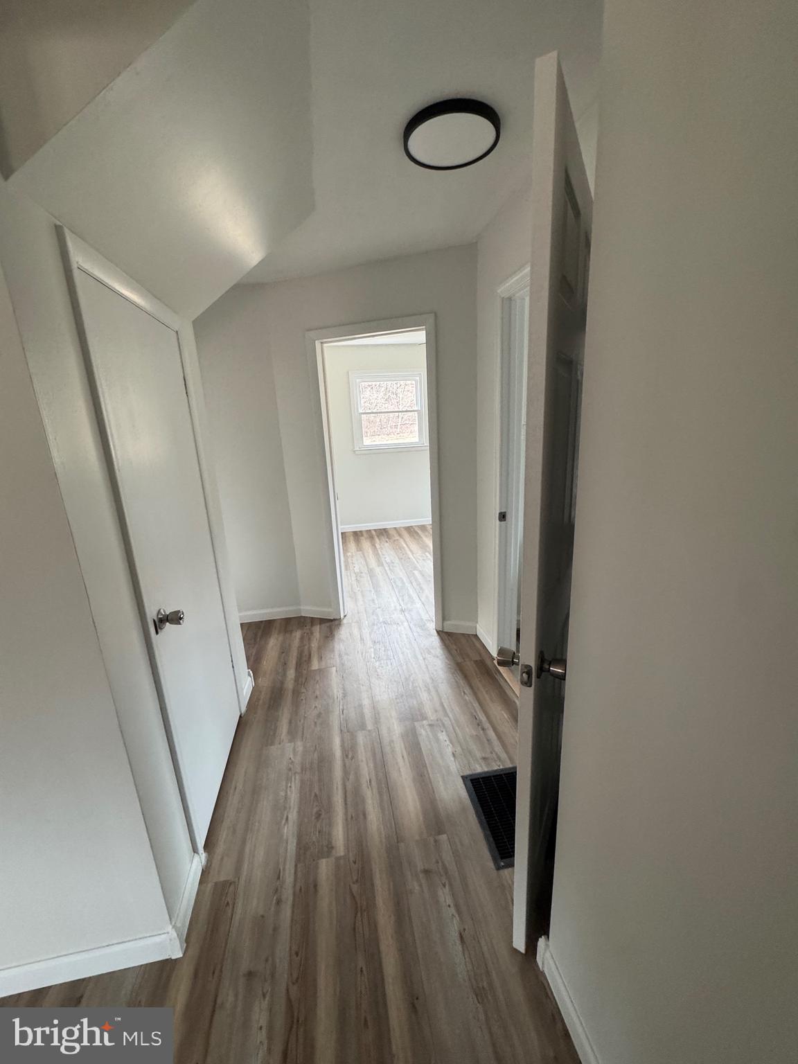 18712 Crossland Road Southwest Rawlings, MD 21557 - Photo 69 of 89 a view of a hallway with wooden floor and staircase