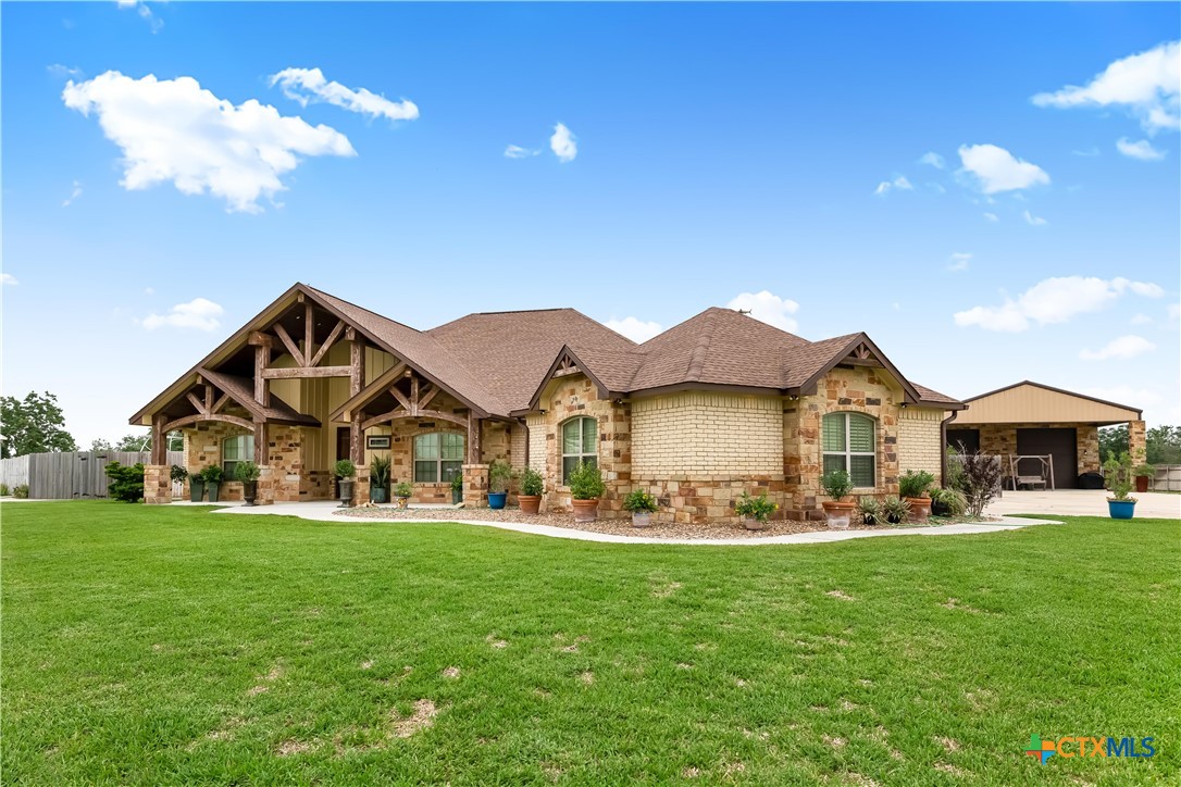 254 Sendera Loop Victoria, TX 77904 - Photo 5 of 48 a front view of a house with a yard and trees