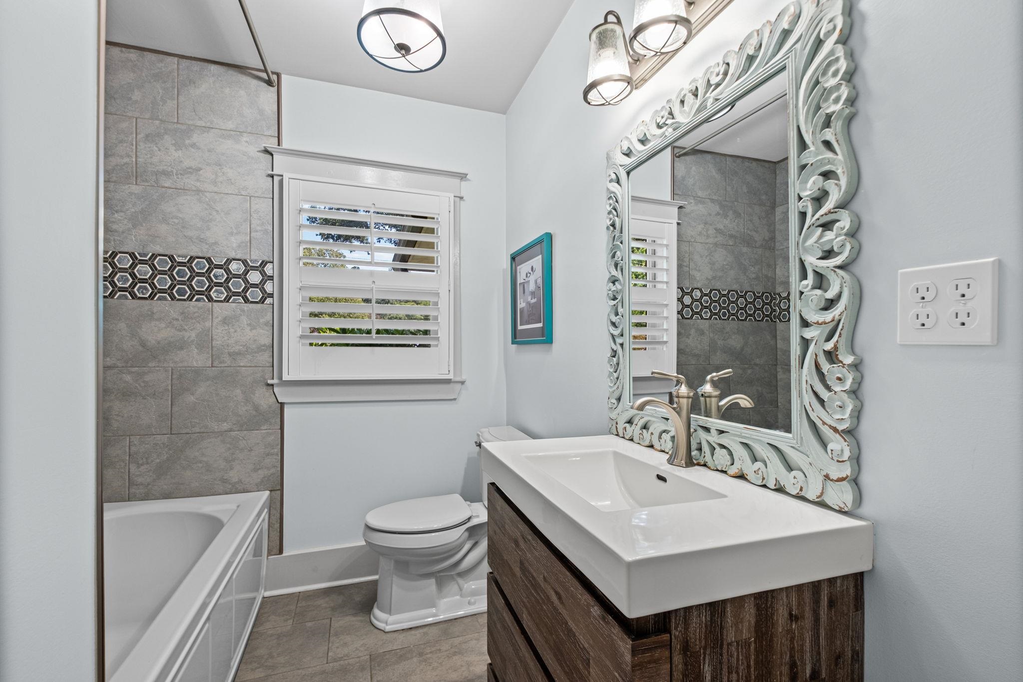 5079 Walnut Grove Road Memphis, TN 38117 - Photo 27 of 40 Bathroom with a wood-finish vanity, integrated sink, and an ornate framed mirror