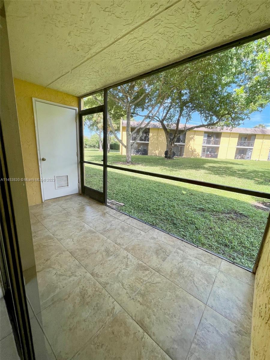 105 Meadows Circle, Unit 105 Boynton Beach, FL 33436 - Photo 13 of 18 a view of a porch and garden