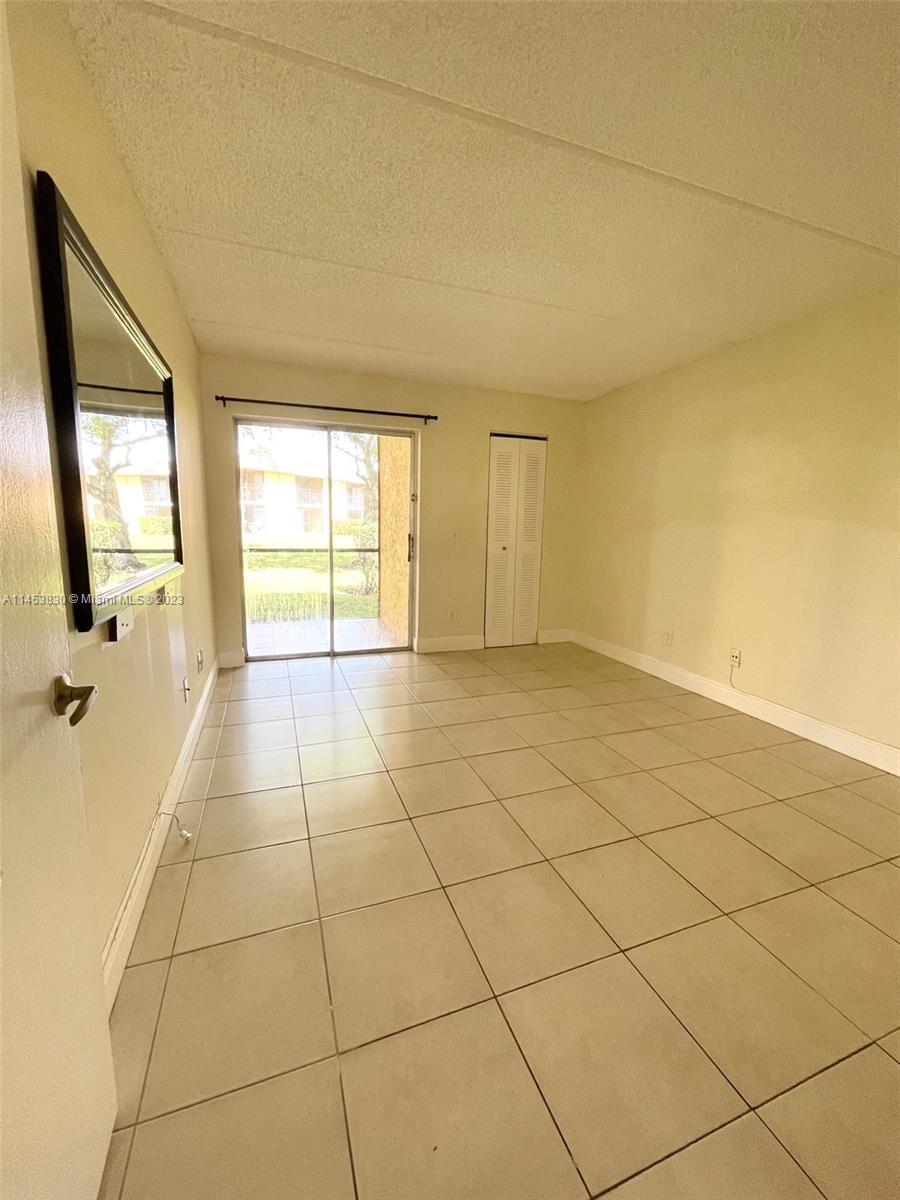 105 Meadows Circle, Unit 105 Boynton Beach, FL 33436 - Photo 16 of 18 a view of an empty room and a window