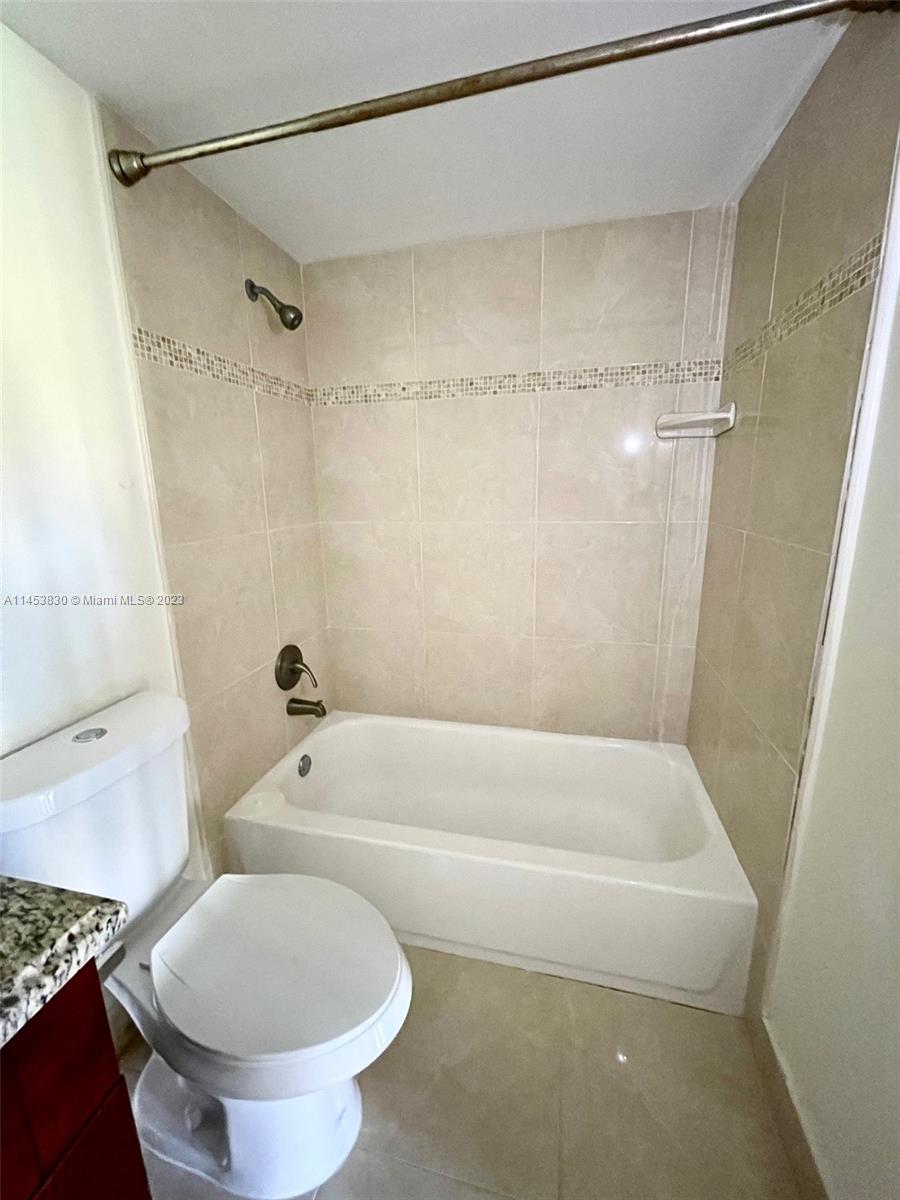 105 Meadows Circle, Unit 105 Boynton Beach, FL 33436 - Photo 17 of 18 a bathroom with a toilet and a shower