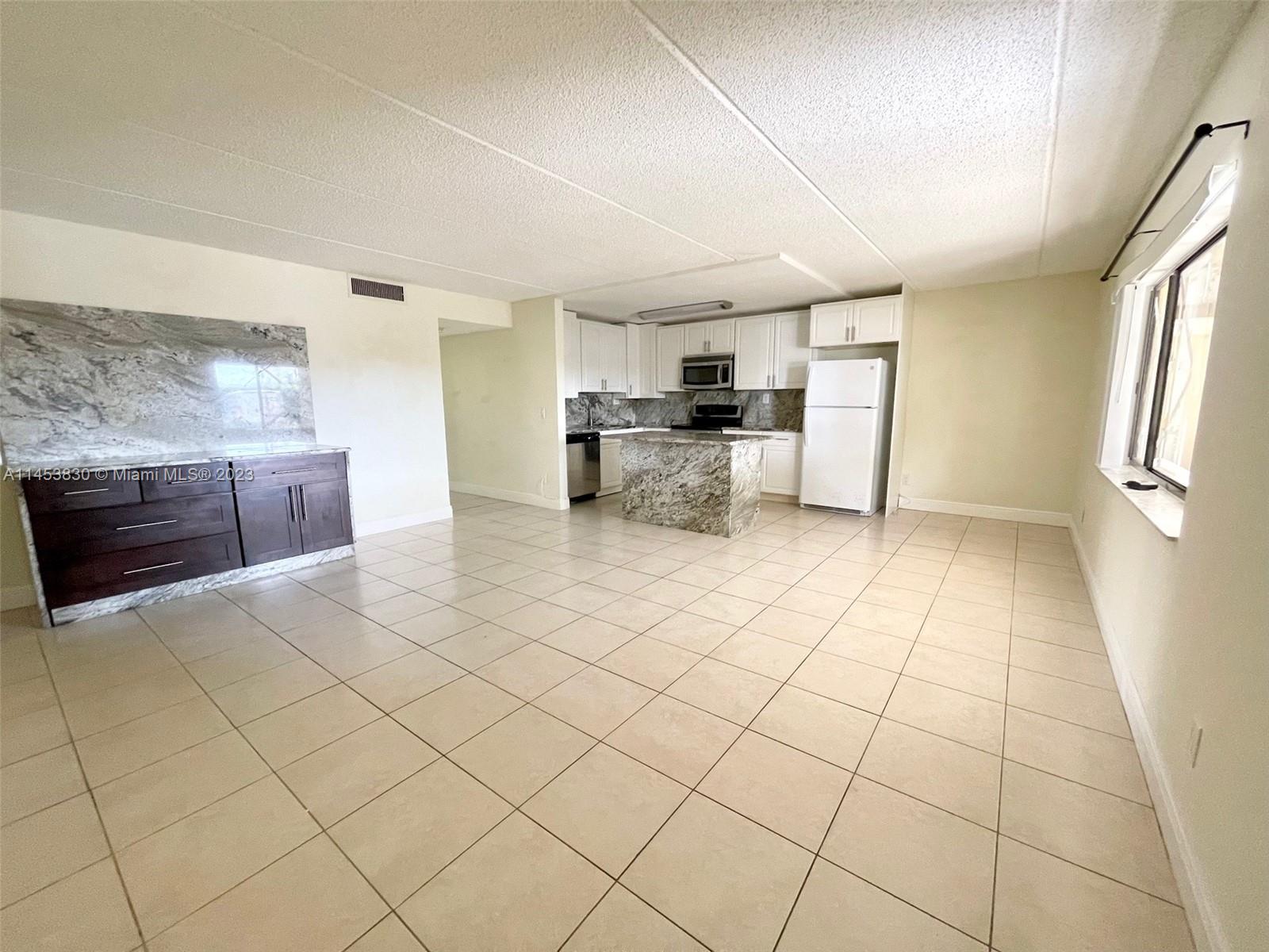 105 Meadows Circle, Unit 105 Boynton Beach, FL 33436 - Photo 8 of 18 a view of kitchen and microwave