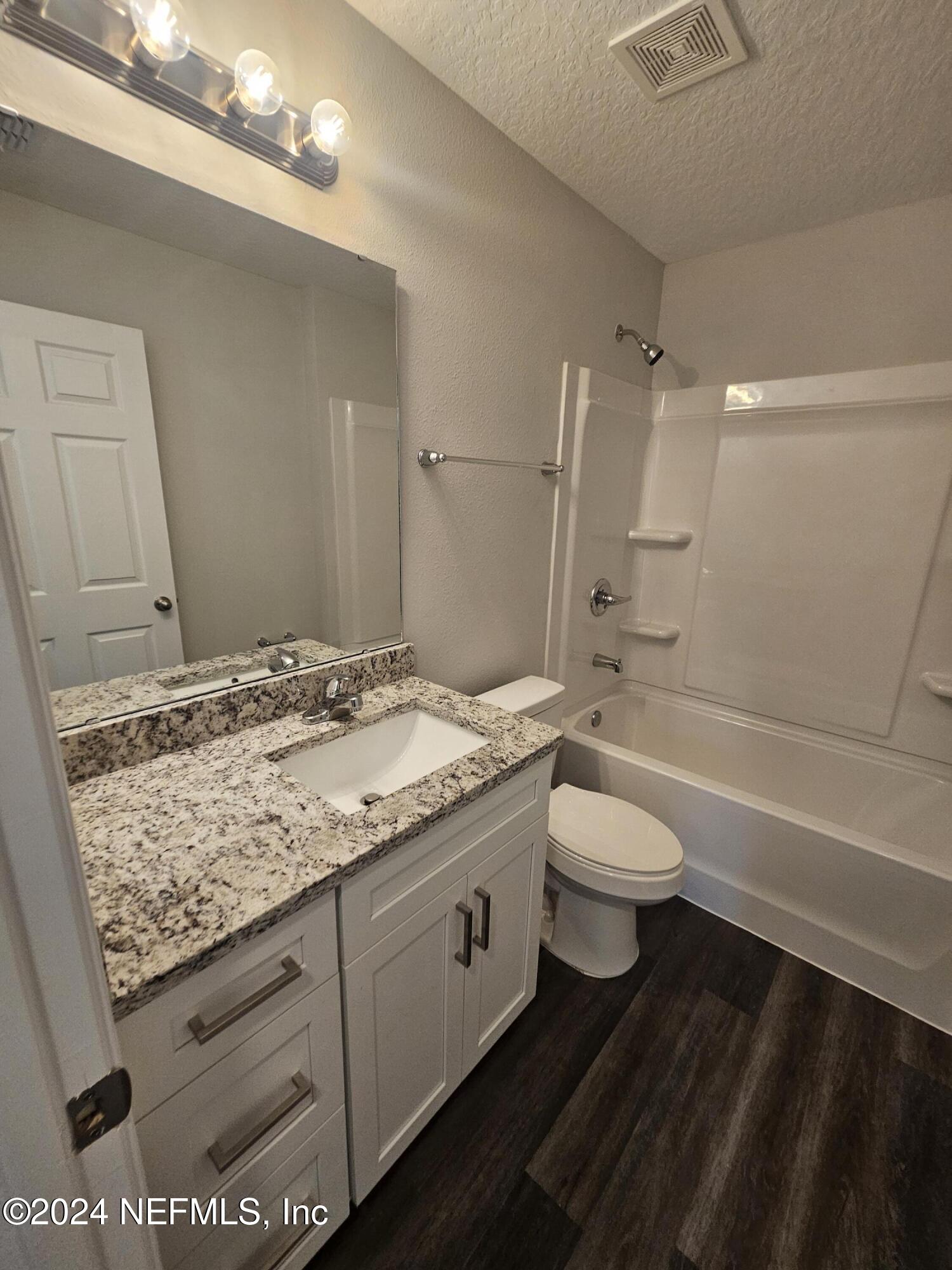 7607 Del Road Jacksonville, FL 32244 - Photo 12 of 15 a bathroom with a granite countertop sink toilet and shower
