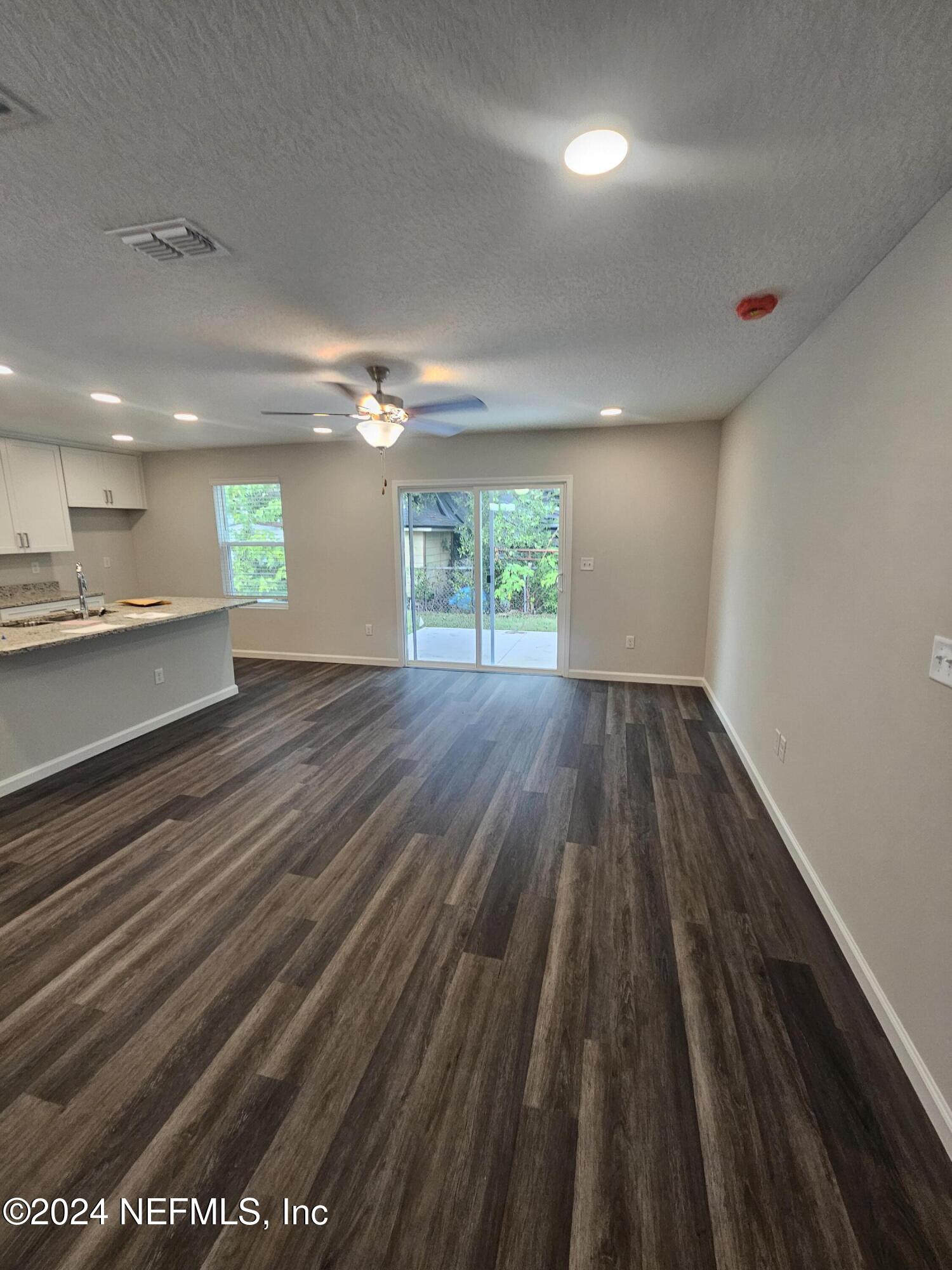 7607 Del Road Jacksonville, FL 32244 - Photo 3 of 15 an empty room with wooden floor and windows