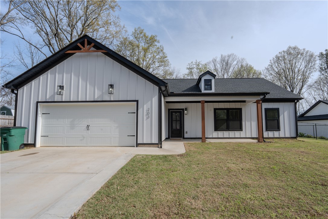 203 Mr Jim's Lane Clinton, SC 29325 - Photo 1 of 28 This charming modern farmhouse features a welcoming facade and a spacious attached garage.