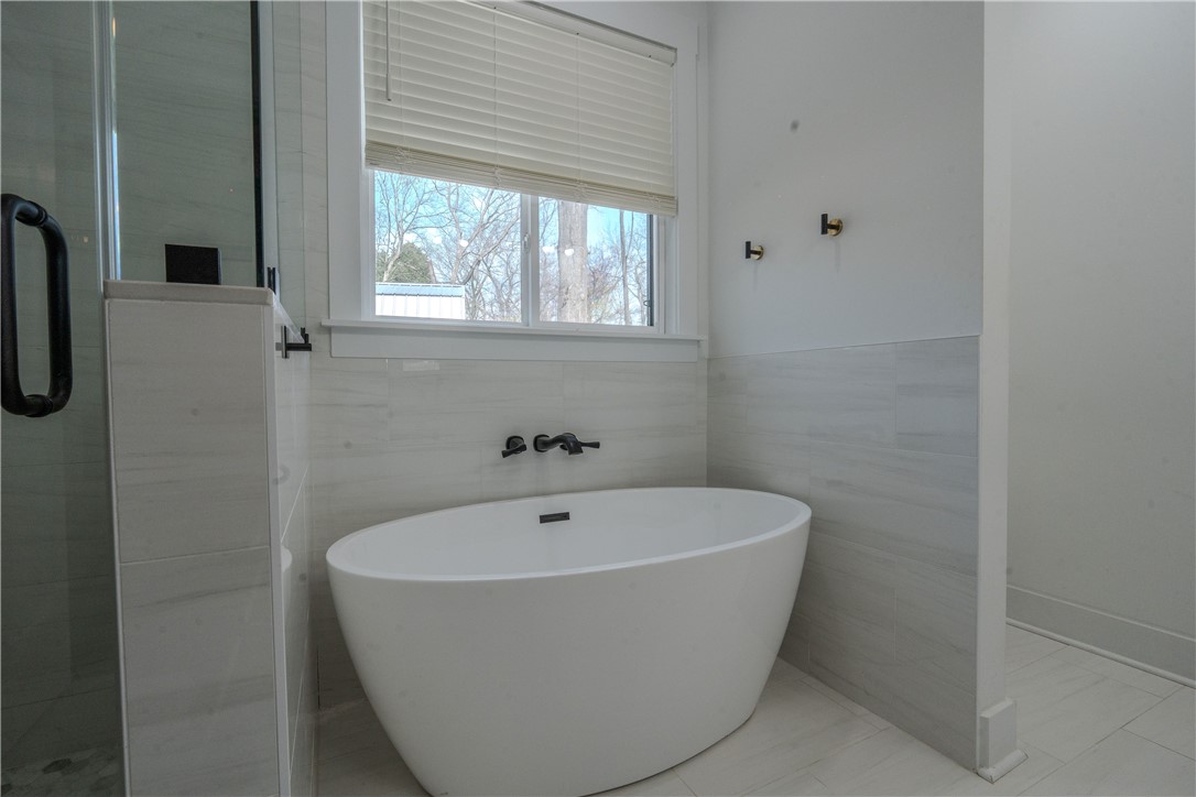 203 Mr Jim's Lane Clinton, SC 29325 - Photo 11 of 28 This serene bathroom offers a luxurious soaking tub for ultimate relaxation.