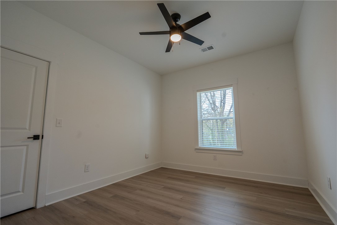 203 Mr Jim's Lane Clinton, SC 29325 - Photo 17 of 28 This spacious room features ample natural light, a ceiling fan, and beautiful flooring.