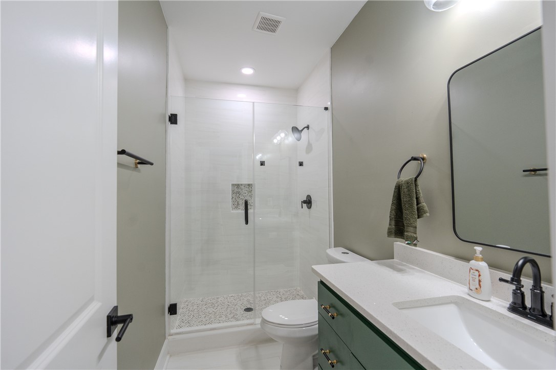 203 Mr Jim's Lane Clinton, SC 29325 - Photo 19 of 28 This bathroom features a contemporary shower and a sleek vanity with ample counter space.