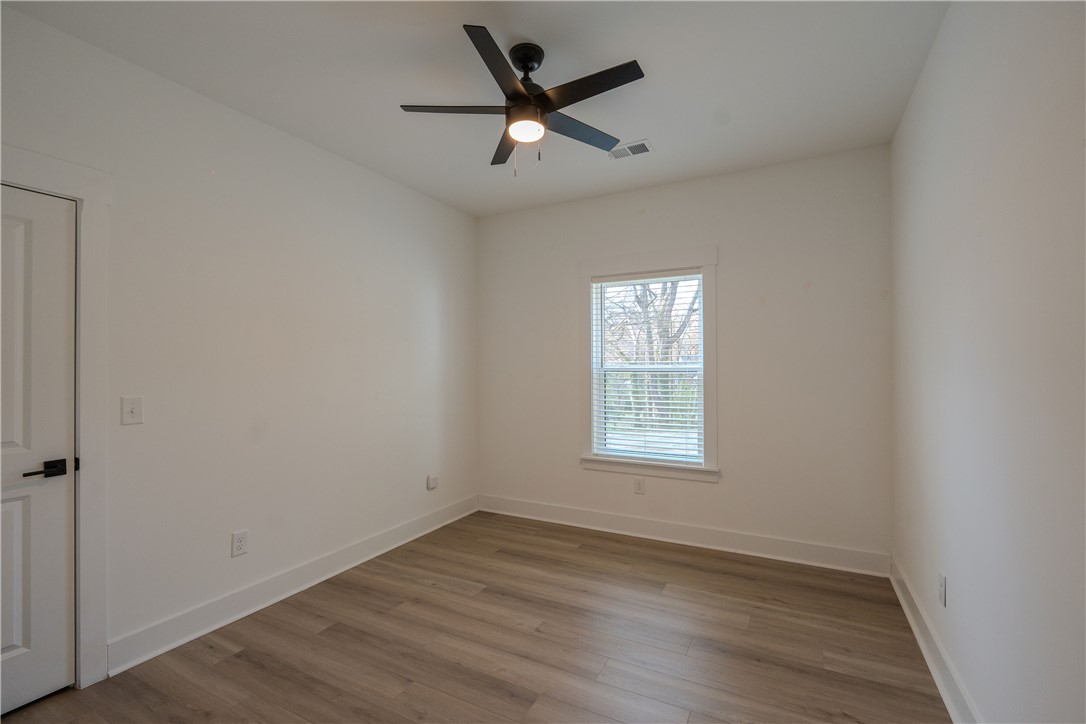 203 Mr Jim's Lane Clinton, SC 29325 - Photo 21 of 28 This spacious bedroom offers ample natural light and modern finishes for comfortable living.