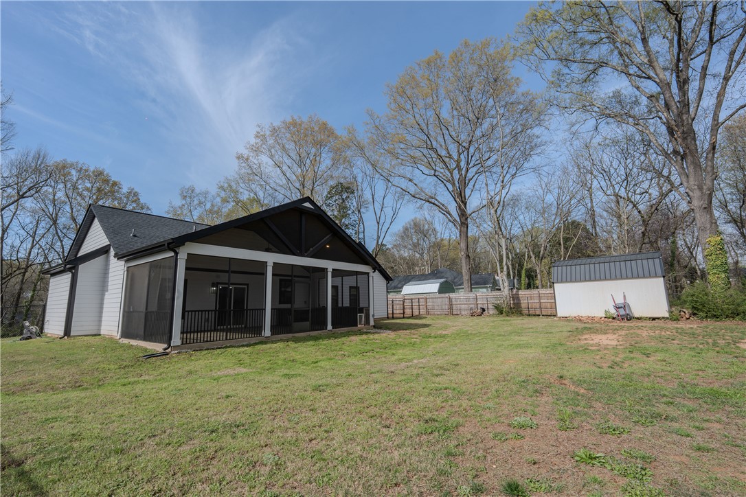203 Mr Jim's Lane Clinton, SC 29325 - Photo 26 of 28 This spacious backyard with a screened porch offers abundant outdoor living potential.
