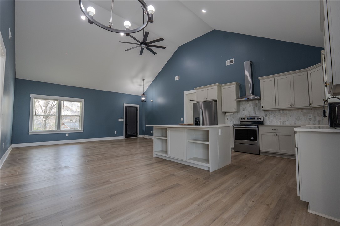 203 Mr Jim's Lane Clinton, SC 29325 - Photo 5 of 28 This expansive kitchen and living area features vaulted ceilings, creating an airy and open atmosphere.