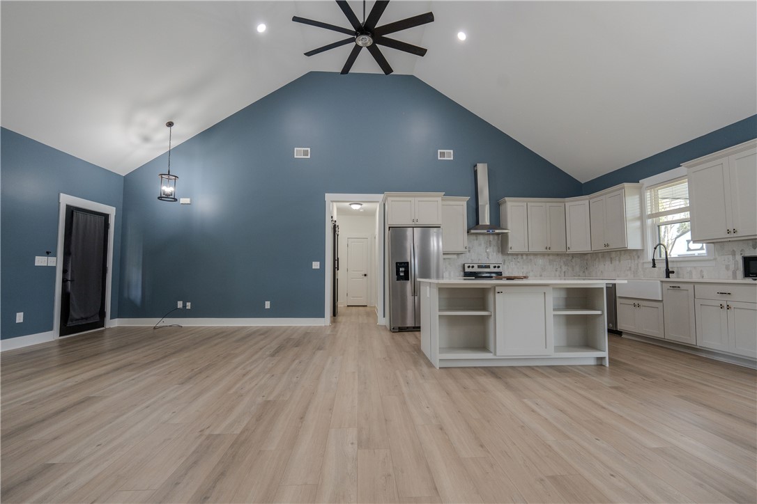 203 Mr Jim's Lane Clinton, SC 29325 - Photo 6 of 28 This airy open-concept living area features a modern kitchen and soaring vaulted ceilings.