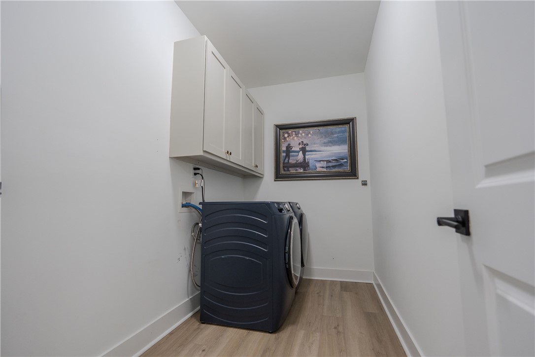 203 Mr Jim's Lane Clinton, SC 29325 - Photo 10 of 28 This dedicated laundry space combines convenience with practical storage solutions.