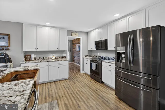 a view of a livingroom with workspace and a window