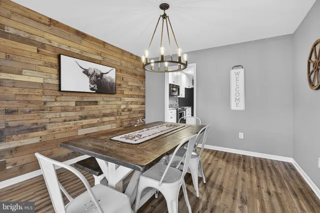 a view of a house with a yard and wooden fence