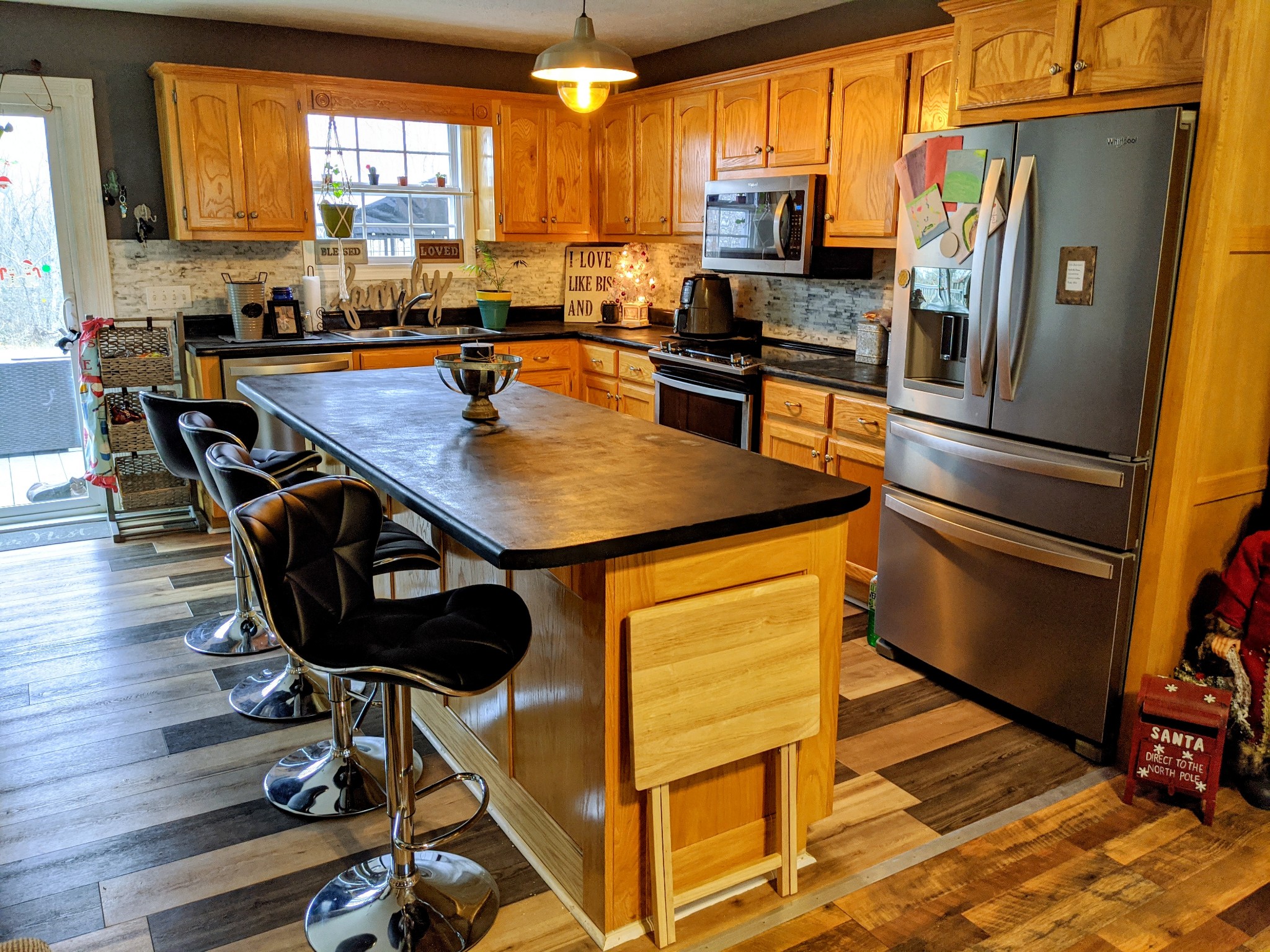 642 Meyers Road Altamont, TN 37301 - Photo 10 of 33 a kitchen with stainless steel appliances granite countertop a stove a refrigerator a sink a dining table and chairs with wooden floor