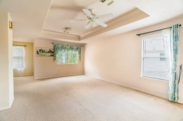 a living room with furniture and a floor to ceiling window