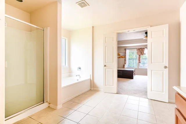 a spacious bathroom with a sink a mirror and a bathtub