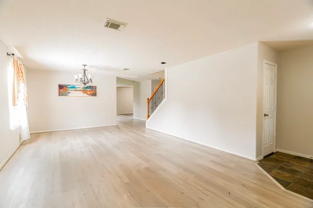 a view of a livingroom with wooden floor and a window