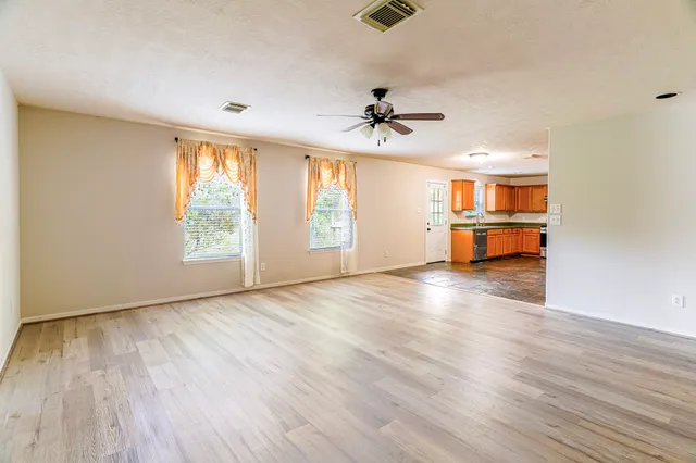 a view of a work space with wooden floor and a ceiling fan