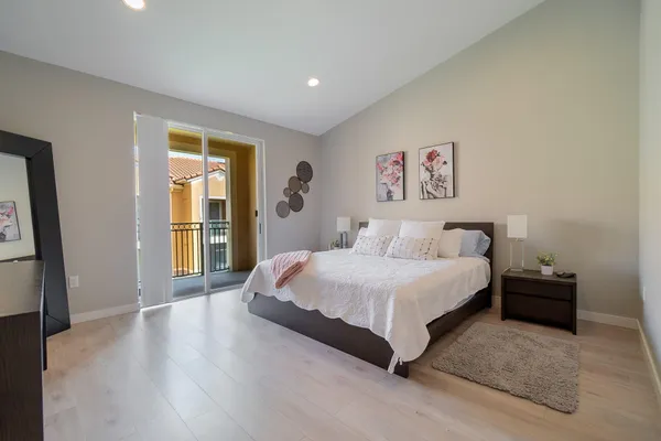 a spacious bedroom with a bed and a window
