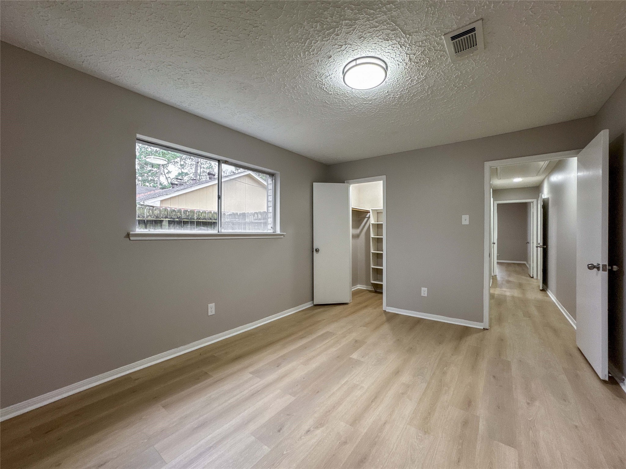 22822 Canyon Lake Drive Spring, TX 77373 - Photo 13 of 26 a view of an empty room with wooden floor and a window