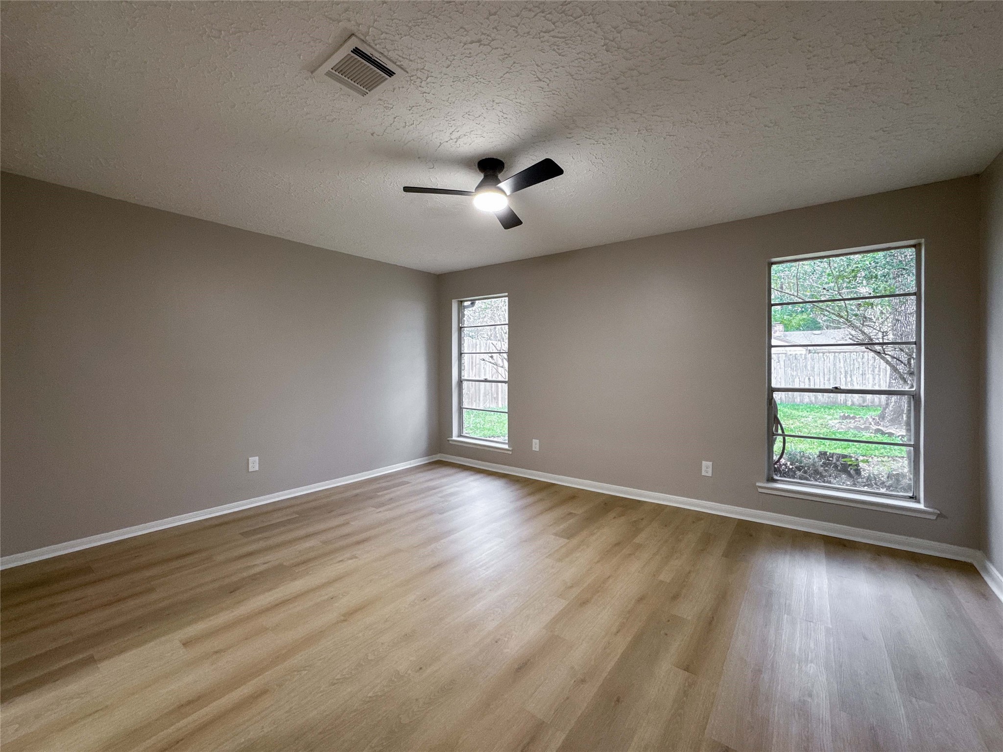 22822 Canyon Lake Drive Spring, TX 77373 - Photo 17 of 26 an empty room with wooden floor and windows