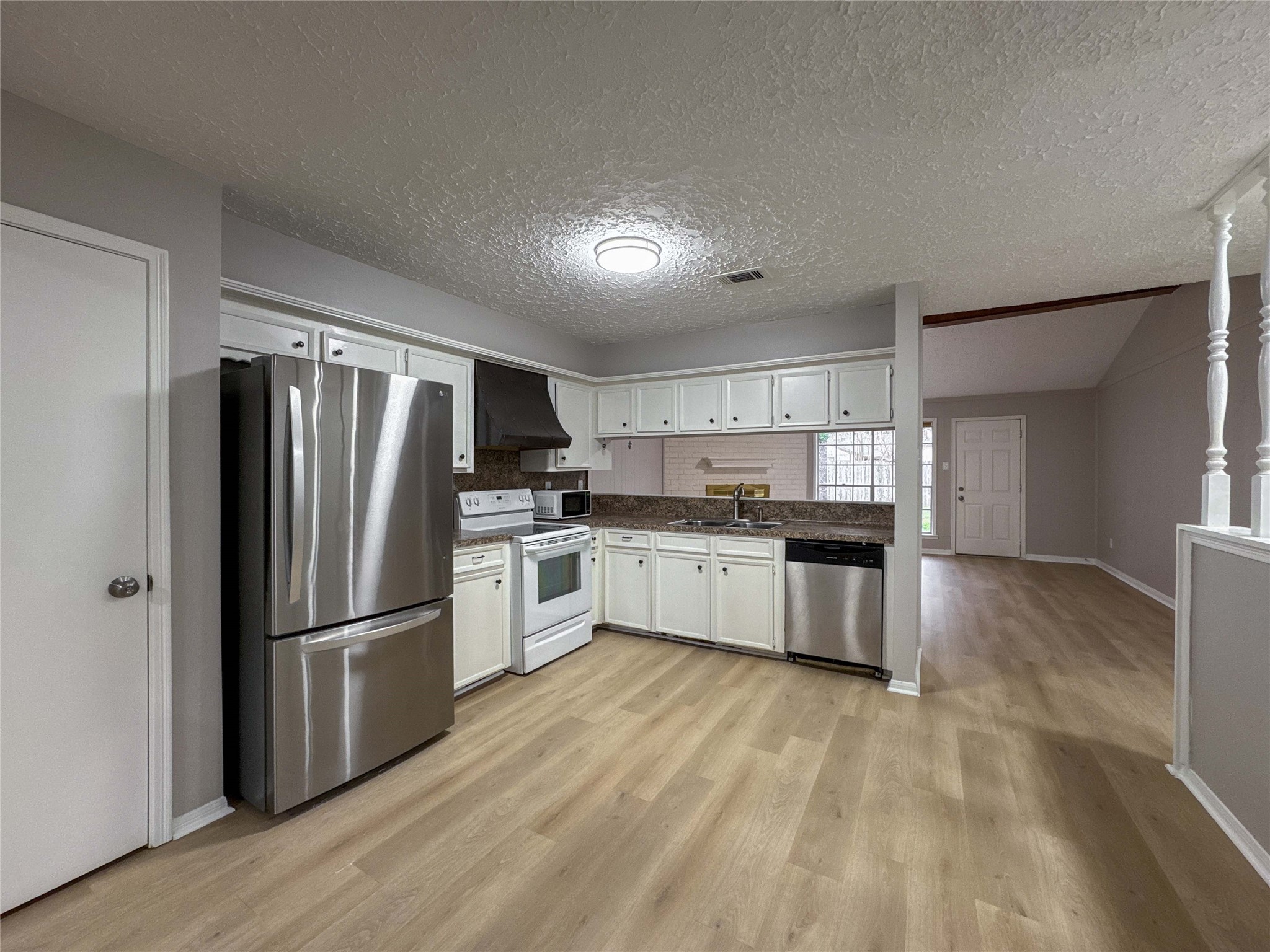 22822 Canyon Lake Drive Spring, TX 77373 - Photo 6 of 26 a kitchen with stainless steel appliances a refrigerator and a stove top oven