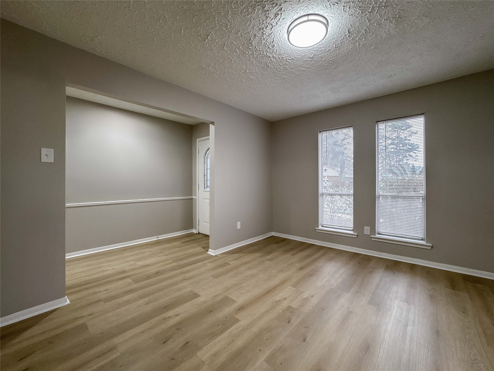 22822 Canyon Lake Drive Spring, TX 77373 - Photo 8 of 26 an empty room with wooden floor and windows