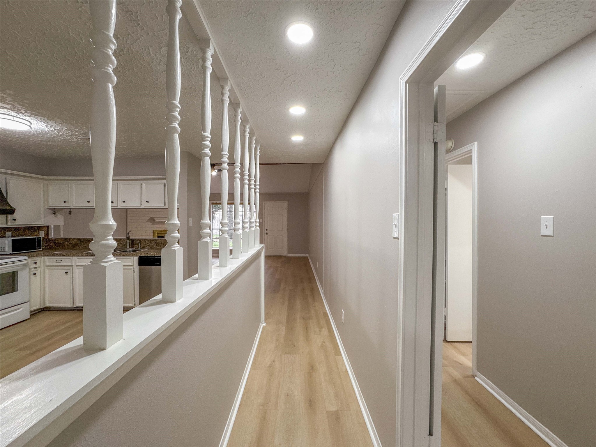 22822 Canyon Lake Drive Spring, TX 77373 - Photo 10 of 26 a view of a kitchen with kitchen island granite countertop lots of counter top space and wooden floor
