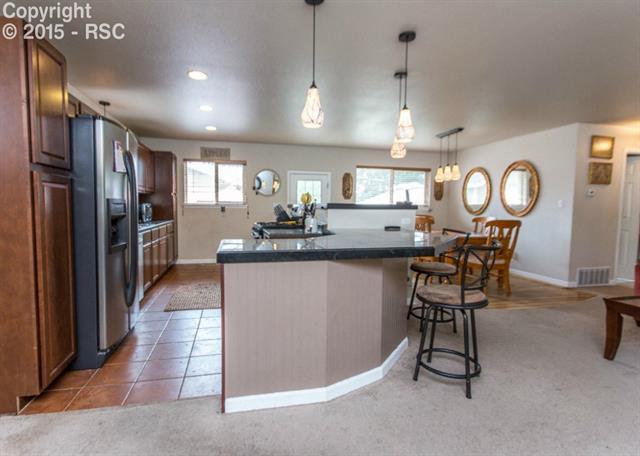 2007 North Chelton Road Colorado Springs, CO 80909 - Photo 9 of 35 Tile and linoleum floors brighten the kitchen area. Plenty of space is available for all of the family traffic during meal times.