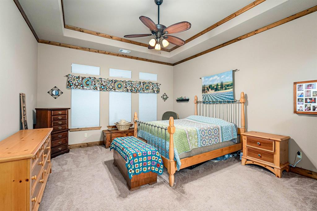 3028 Harrell Road Howe, TX 75459 - Photo 12 of 39 a bedroom with a bed and a chandelier