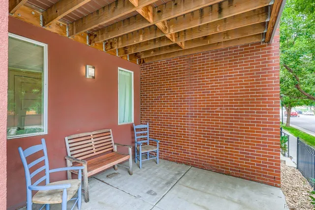 a kitchen with stainless steel appliances kitchen island granite countertop a dining table chairs and a refrigerator