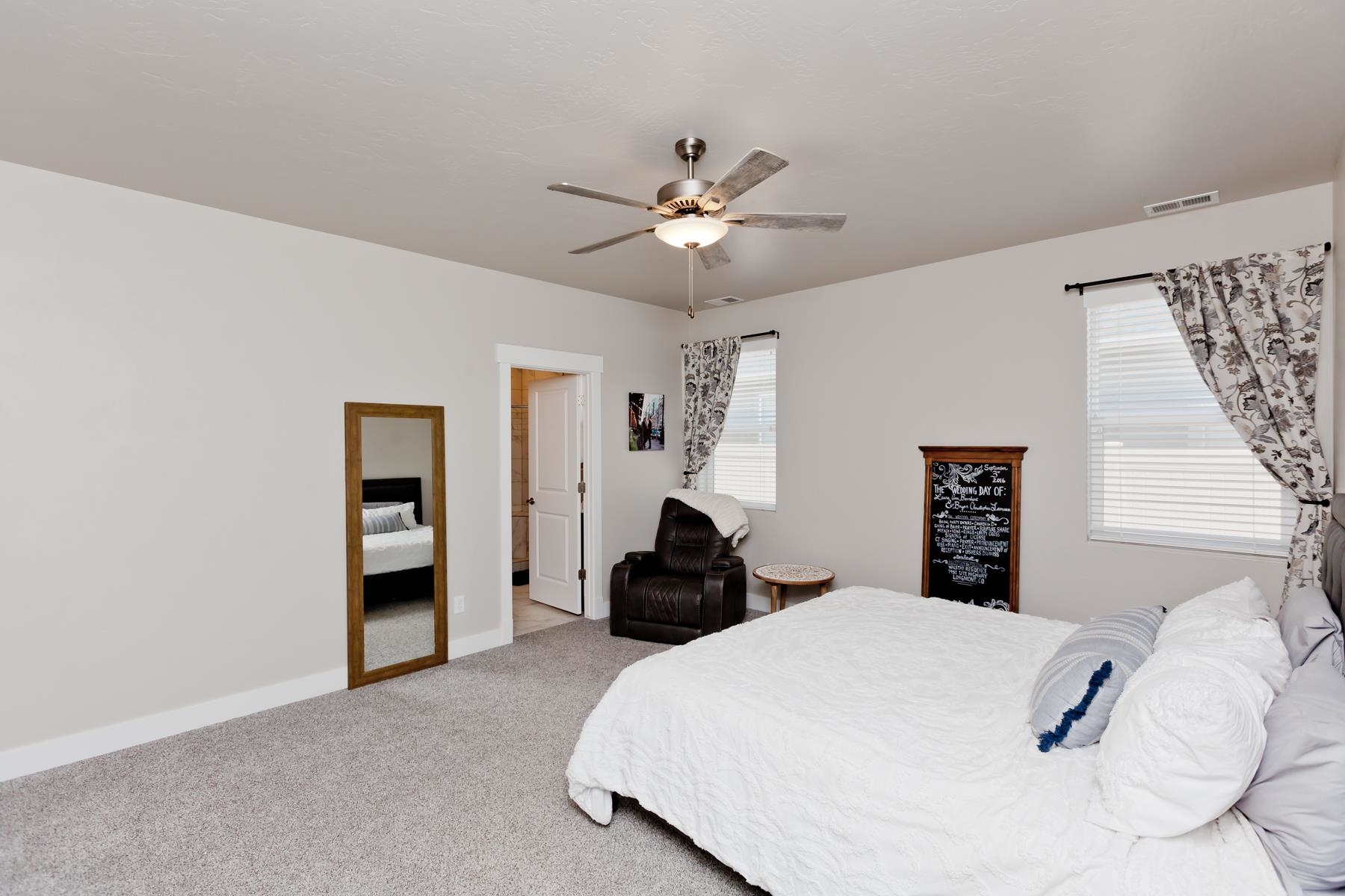 628 Thunder Ridge Drive Grand Junction, CO 81504 - Photo 14 of 37 a bedroom with a bed and a chandelier