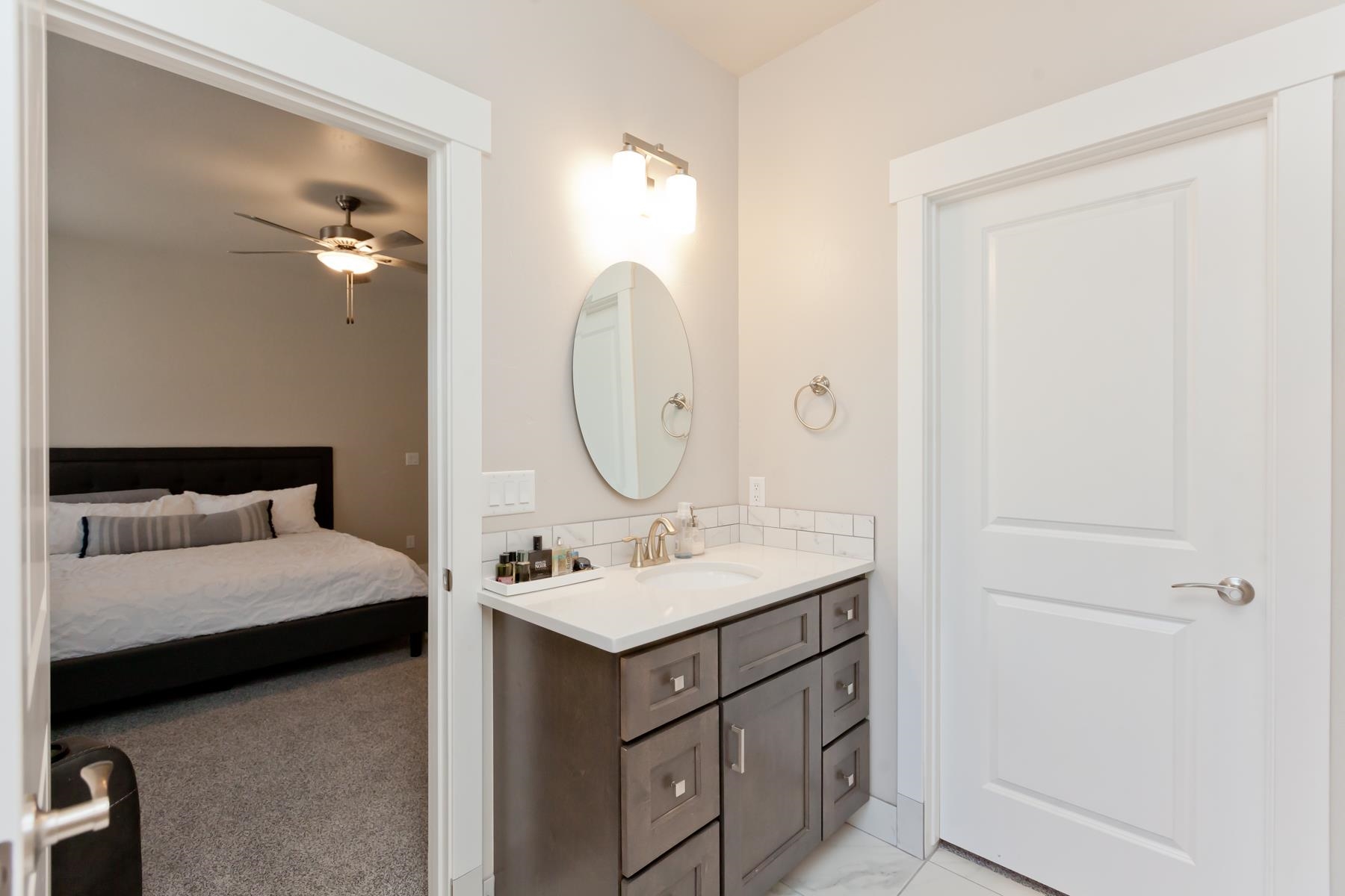 628 Thunder Ridge Drive Grand Junction, CO 81504 - Photo 21 of 37 a en suite bathroom with a double vanity sink and a mirror