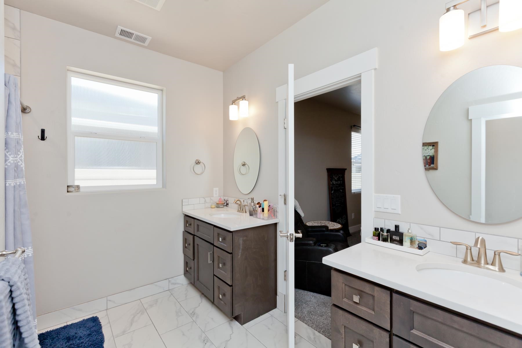 628 Thunder Ridge Drive Grand Junction, CO 81504 - Photo 22 of 37 a bathroom with a double vanity sink and a mirror