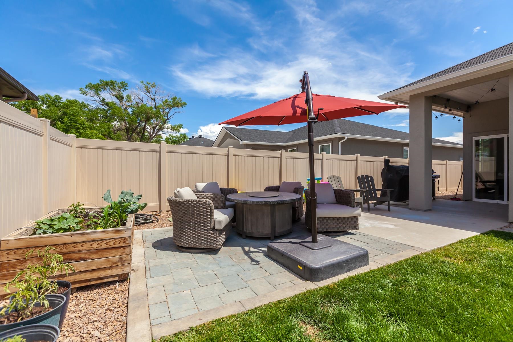 628 Thunder Ridge Drive Grand Junction, CO 81504 - Photo 31 of 37 a view of a patio with table and chairs under an umbrella