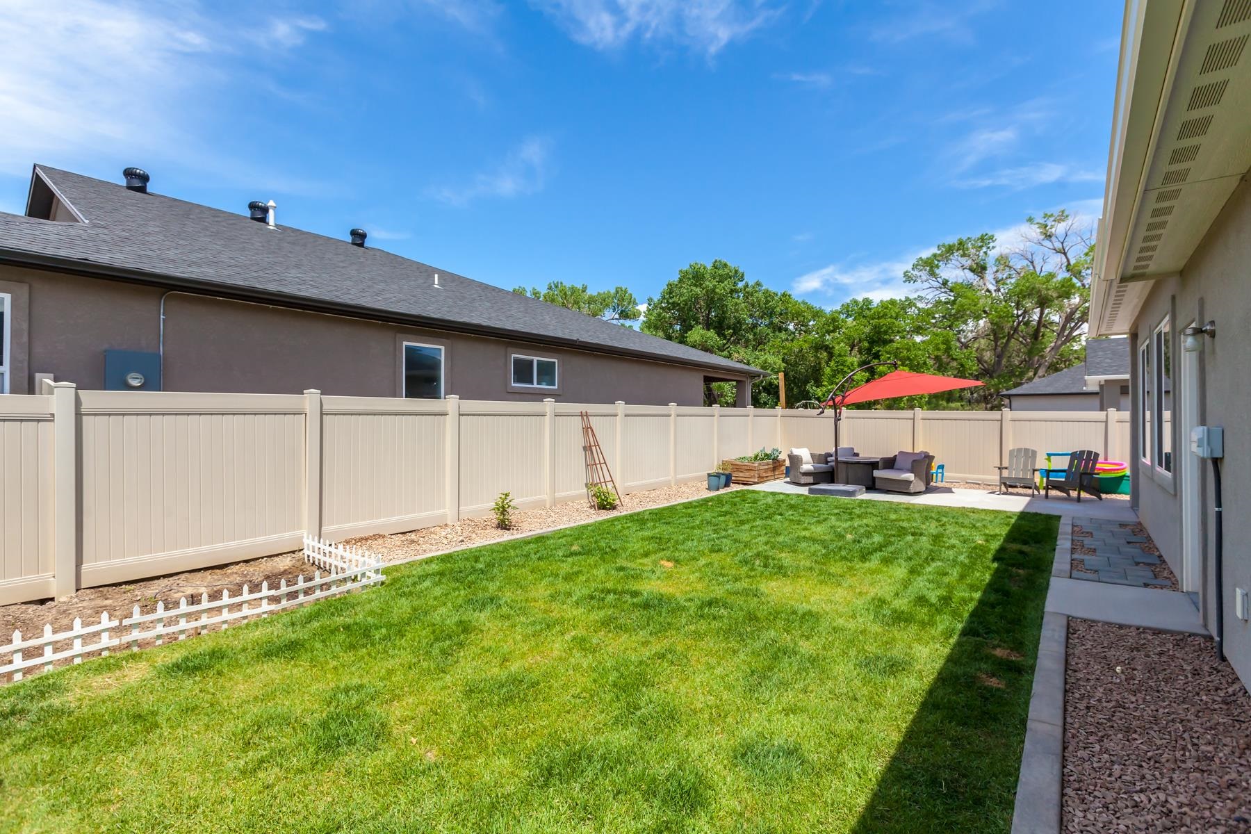 628 Thunder Ridge Drive Grand Junction, CO 81504 - Photo 33 of 37 a view of a backyard with plants and a patio