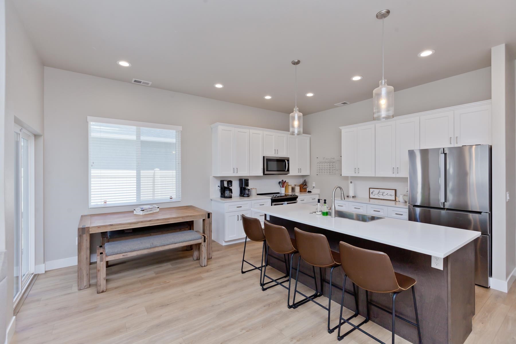 628 Thunder Ridge Drive Grand Junction, CO 81504 - Photo 8 of 37 a kitchen with a dining table chairs and refrigerator
