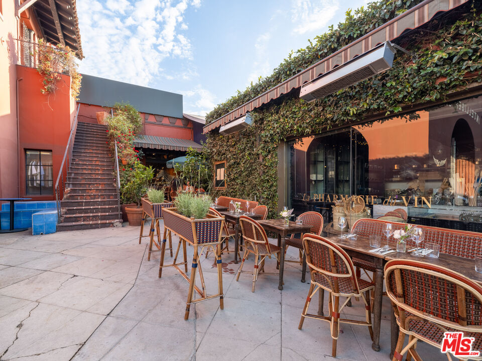 3924 Sunset Boulevard Los Angeles, CA 90029 - Photo 15 of 70 a view of a patio with dining table and chairs with a barbeque grill and plants