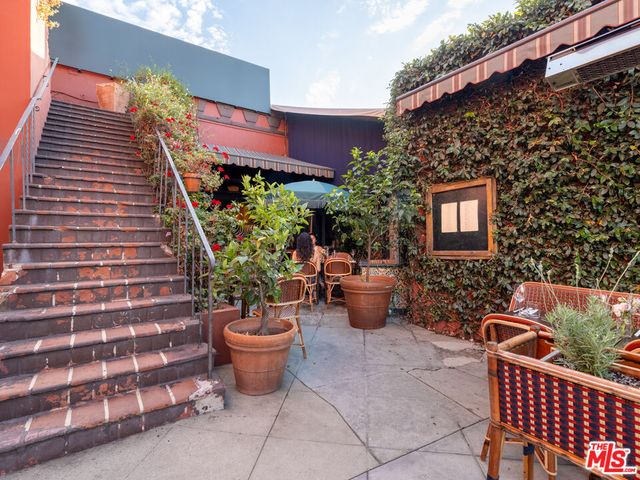 a view of a patio with couches and potted plants