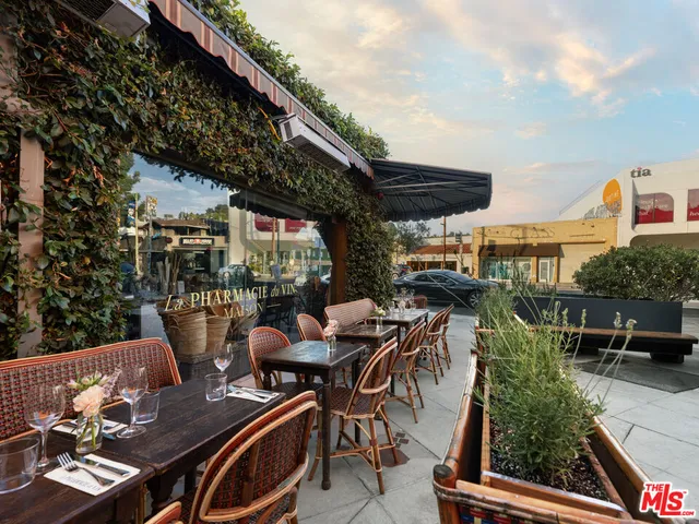 an outdoor living area with furniture and umbrella