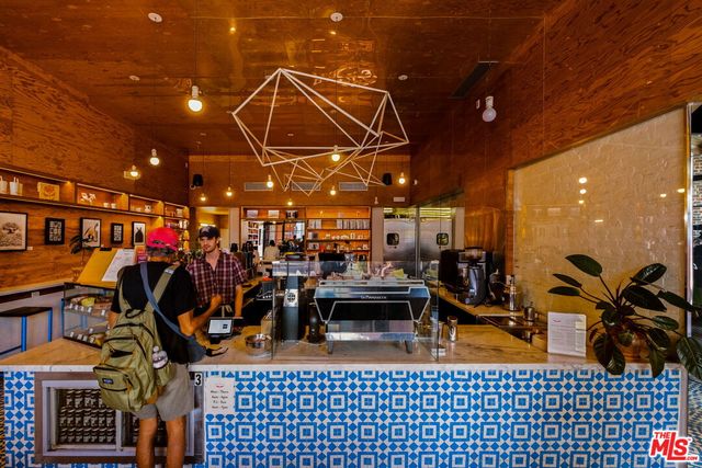 a view of a patio with table and chairs under an umbrella
