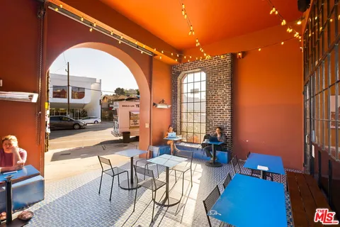 a view of a patio with table and chairs under an umbrella
