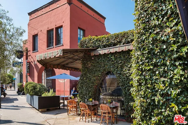 a view of a a dining room with furniture and chandelier