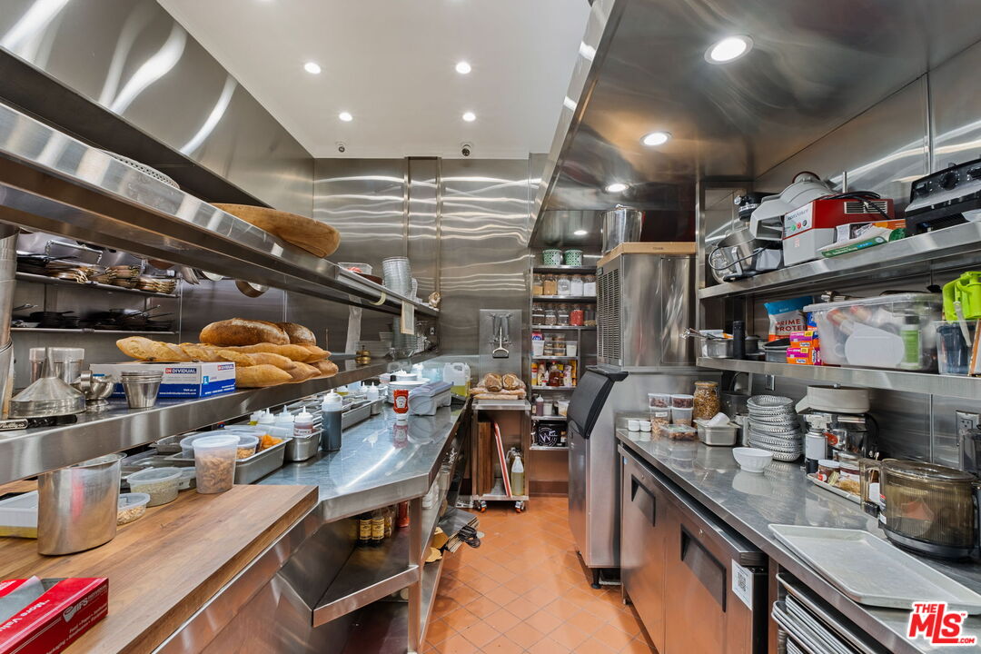 3924 Sunset Boulevard Los Angeles, CA 90029 - Photo 38 of 70 a kitchen with lots of wooden furniture and appliances