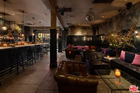 a living room with lots of furniture and chandelier
