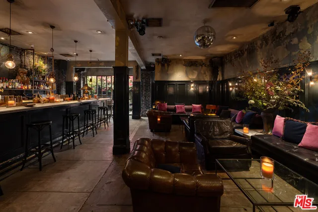 a living room with lots of furniture and chandelier